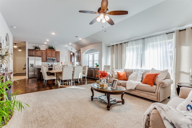 living room with dark hardwood / wood-style floors, ceiling fan, and lofted ceiling