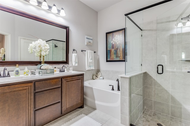 bathroom featuring tile patterned floors, vanity, and shower with separate bathtub