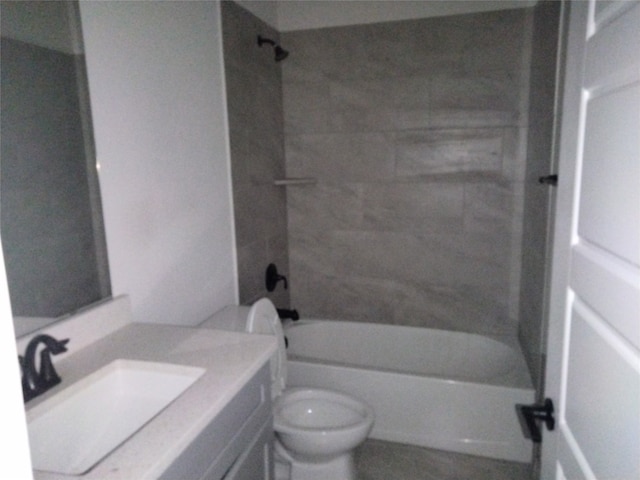 full bathroom featuring vanity, toilet, and tiled shower / bath combo