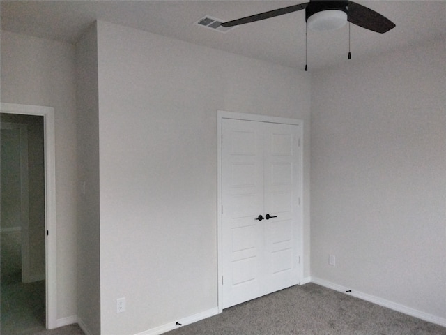 unfurnished bedroom with carpet flooring, ceiling fan, and a closet