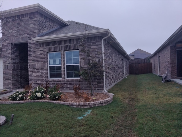 view of property exterior with a lawn