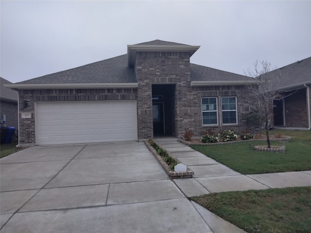 view of front of home with a front lawn and a garage