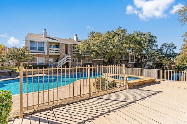 view of pool with an in ground hot tub and a patio