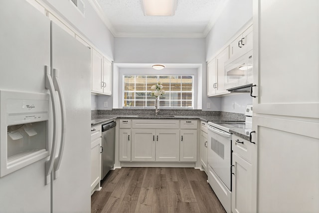 kitchen with white cabinetry, sink, wood-type flooring, and white appliances