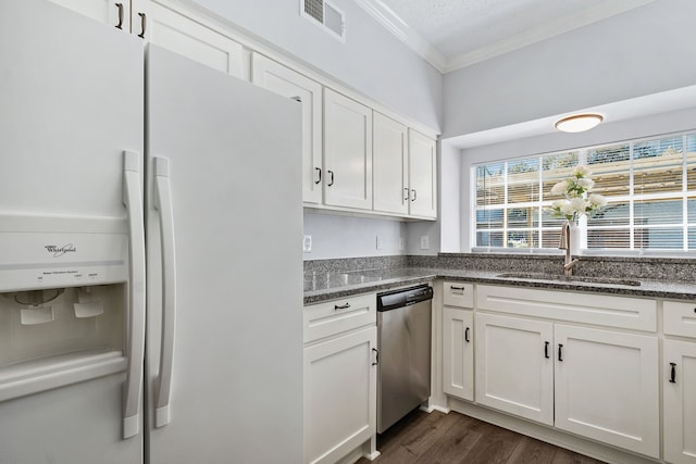 kitchen with white cabinetry, white fridge with ice dispenser, stainless steel dishwasher, and sink