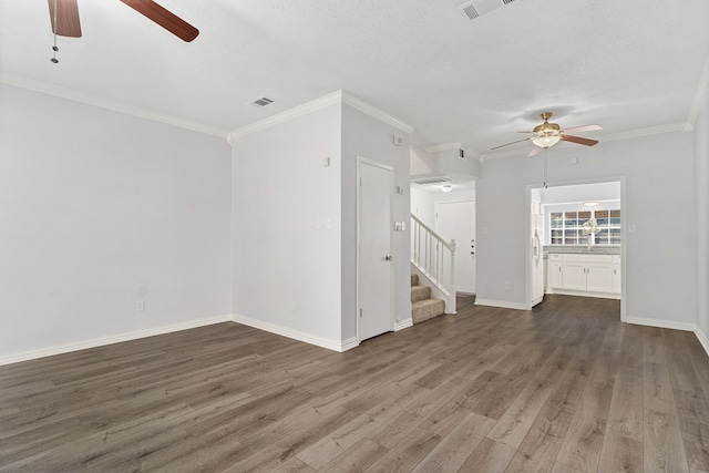 unfurnished living room with a textured ceiling, dark hardwood / wood-style floors, ceiling fan, and crown molding