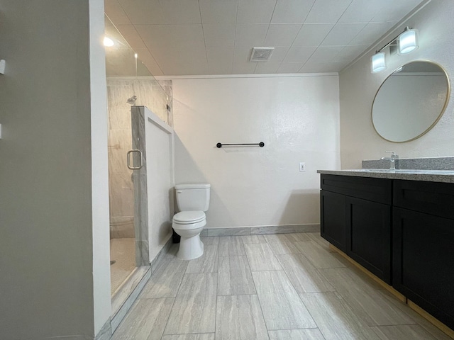 bathroom featuring vanity, toilet, and a shower with door