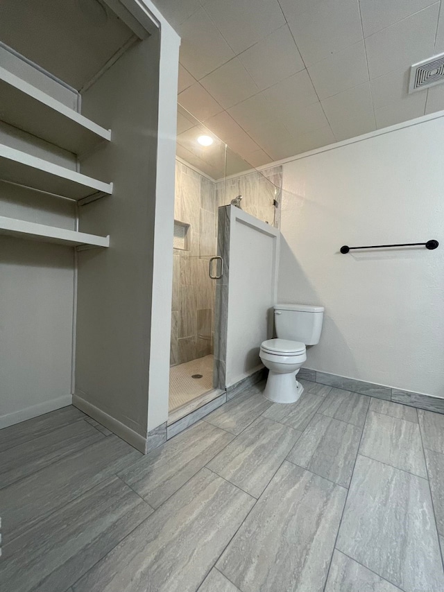 bathroom featuring toilet and walk in shower