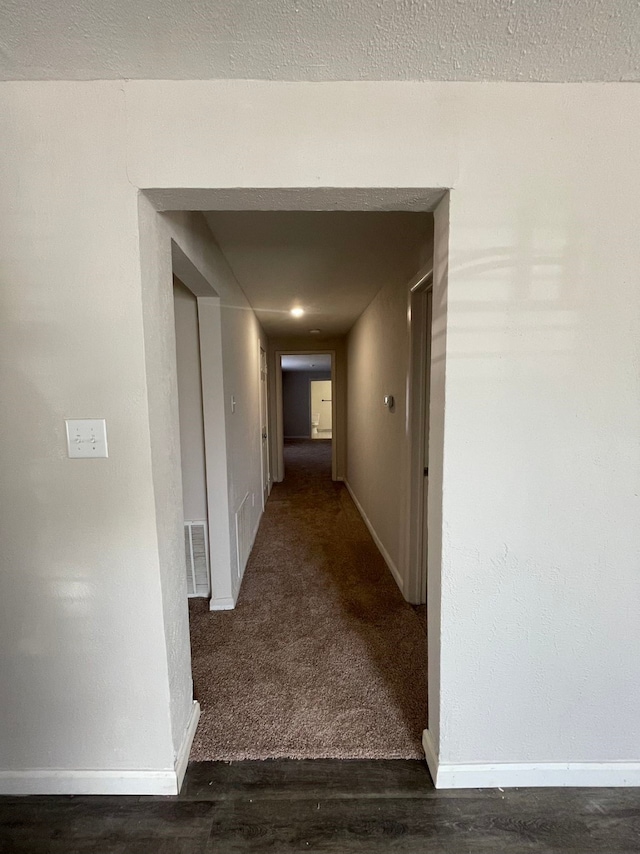 hall with dark hardwood / wood-style flooring