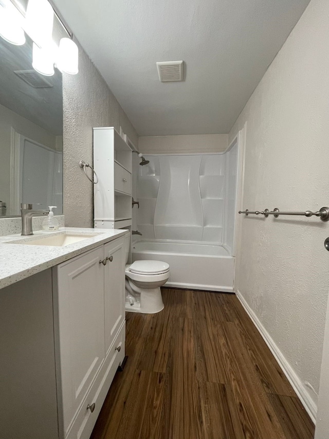 full bathroom featuring wood-type flooring, vanity, shower / bath combination, and toilet