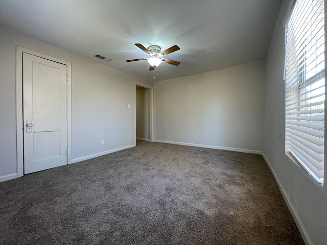 unfurnished room with ceiling fan and carpet floors