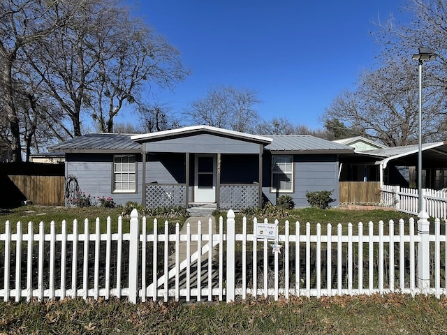 2925 Janet Dr, Wylie, TX 75098 - view of front of house with a porch, a fenced front yard, and metal roof