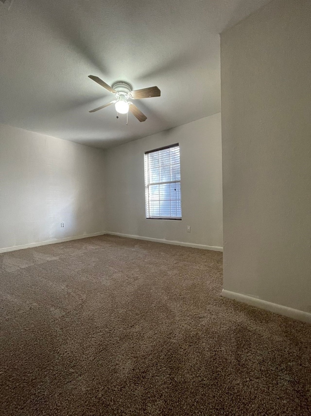 unfurnished room with carpet flooring and ceiling fan