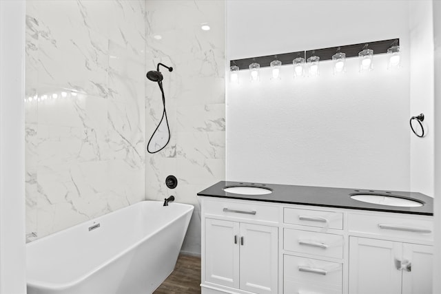 bathroom featuring hardwood / wood-style flooring, vanity, and a bath