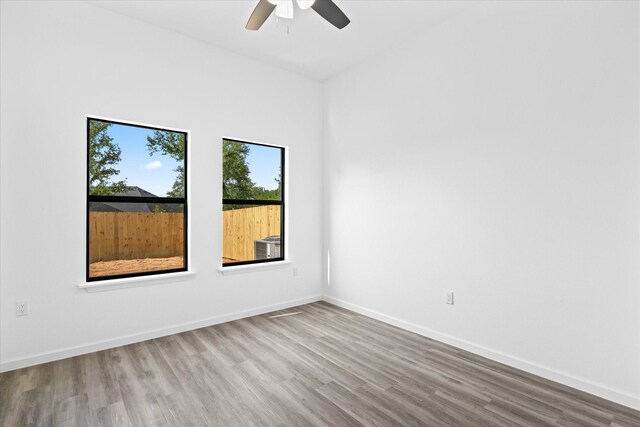 unfurnished room with ceiling fan and hardwood / wood-style flooring