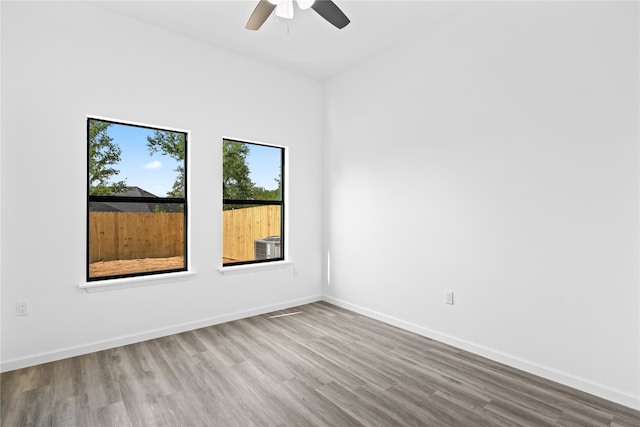 unfurnished room featuring hardwood / wood-style flooring and ceiling fan