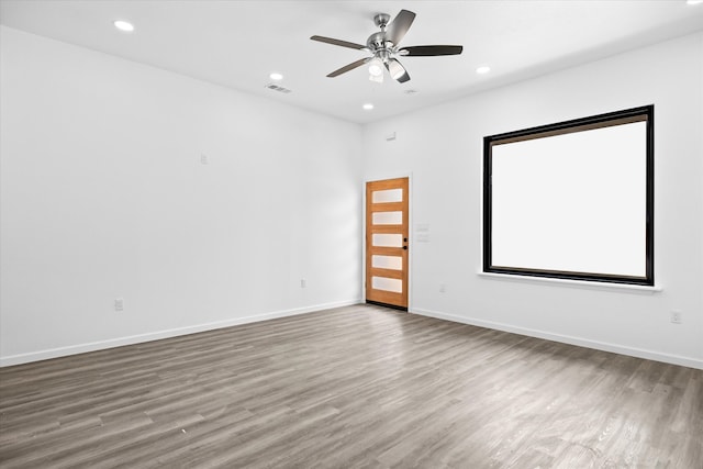 spare room with hardwood / wood-style floors and ceiling fan