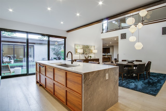 kitchen with sink, hanging light fixtures, and plenty of natural light