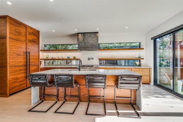 bar featuring decorative backsplash, light stone countertops, and sink