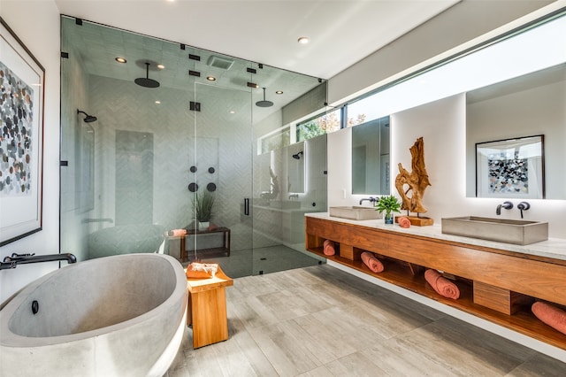 bathroom featuring separate shower and tub and vanity