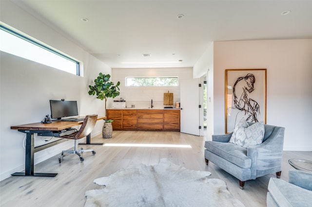 office with light wood-type flooring