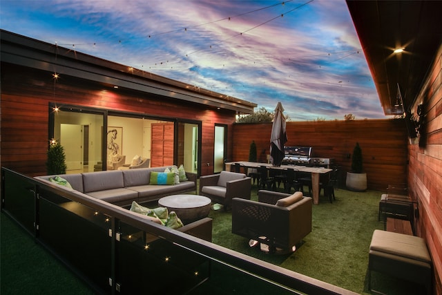 patio terrace at dusk featuring an outdoor living space