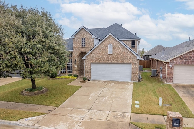 view of property with a front lawn, a garage, and cooling unit