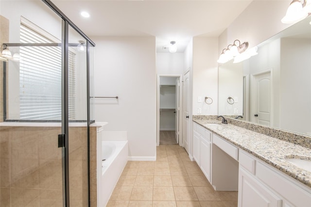 bathroom featuring a sink, a stall shower, double vanity, and tile patterned flooring