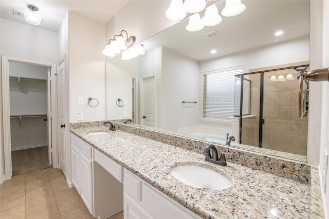 full bathroom featuring a sink, a bath, a shower stall, and tile patterned floors