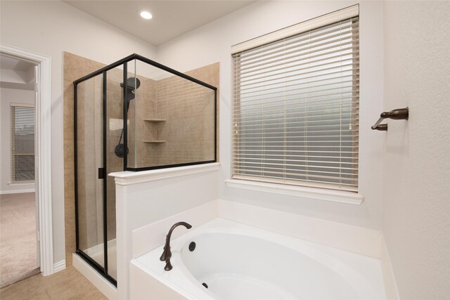 bathroom featuring tile patterned flooring and plus walk in shower