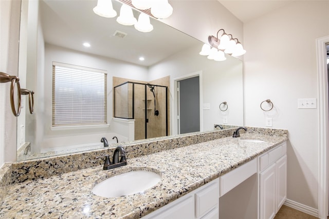 bathroom with double vanity, visible vents, a shower stall, and a sink