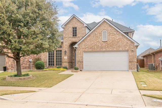 traditional home featuring a front yard, central AC unit, and brick siding