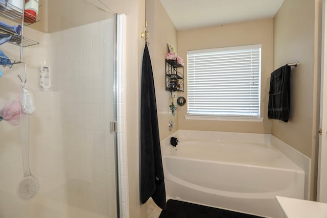 bathroom featuring independent shower and bath