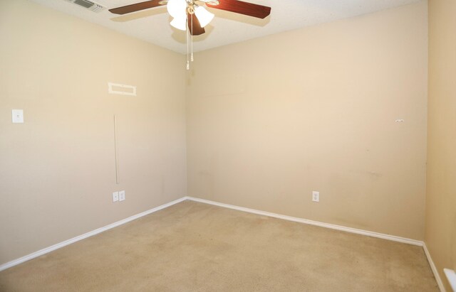 carpeted spare room featuring ceiling fan