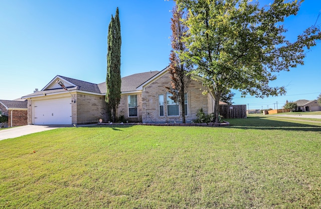 ranch-style home featuring a front yard and a garage