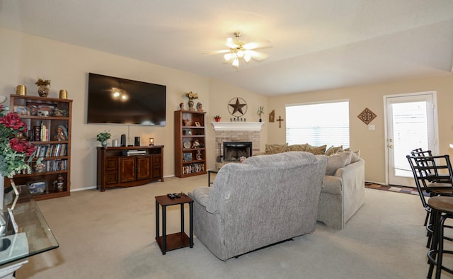 carpeted living room featuring ceiling fan, a fireplace, and vaulted ceiling