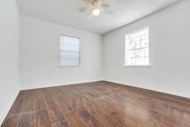 unfurnished room featuring ceiling fan, dark hardwood / wood-style flooring, and a textured ceiling