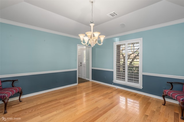 sitting room featuring hardwood / wood-style floors, vaulted ceiling, an inviting chandelier, and crown molding