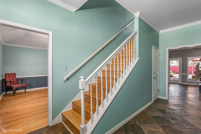 staircase with hardwood / wood-style flooring and ornamental molding