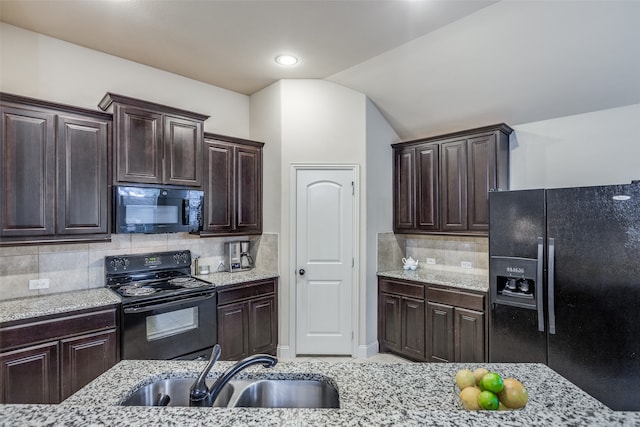 kitchen with black appliances, dark brown cabinetry, sink, and tasteful backsplash