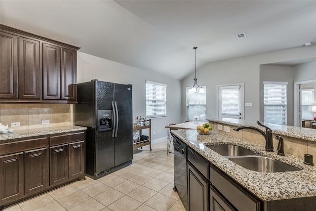 kitchen with lofted ceiling, black refrigerator with ice dispenser, an inviting chandelier, sink, and dark brown cabinets