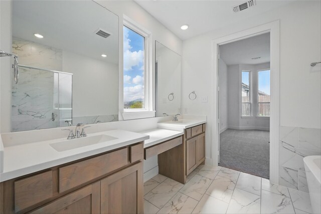 bathroom with a soaking tub, visible vents, marble finish floor, and a marble finish shower