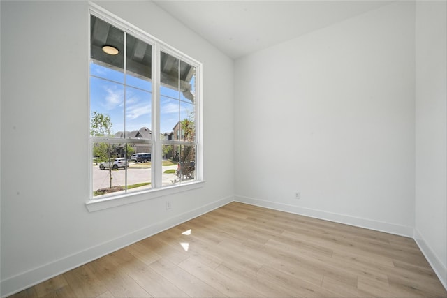 unfurnished room featuring light wood-style floors and baseboards