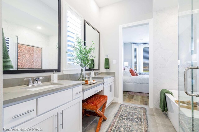 bathroom with wood-type flooring, a shower with door, and a wealth of natural light