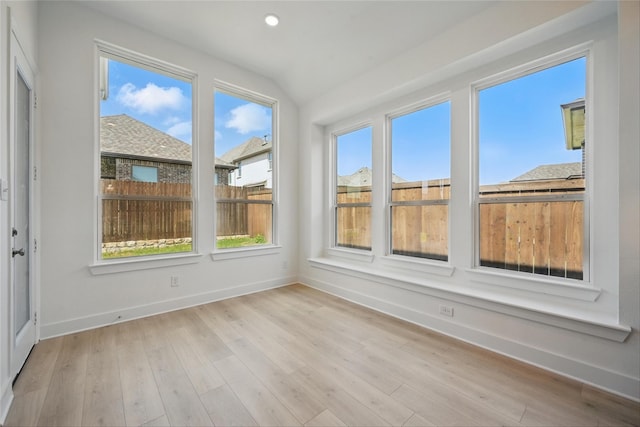 unfurnished sunroom with a wealth of natural light and baseboards