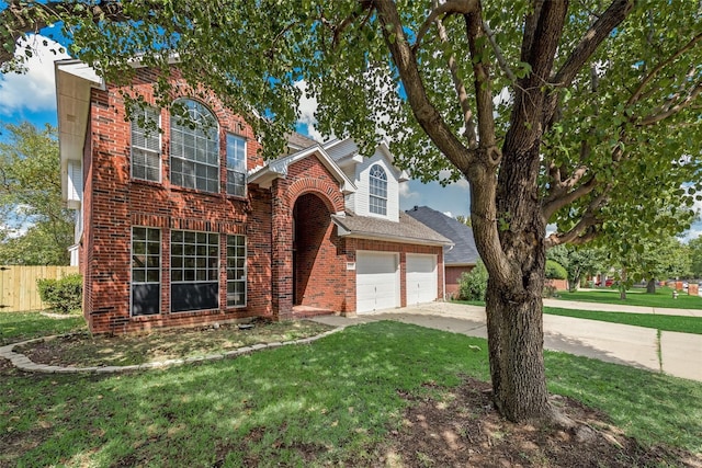 view of front of property with a garage and a front lawn