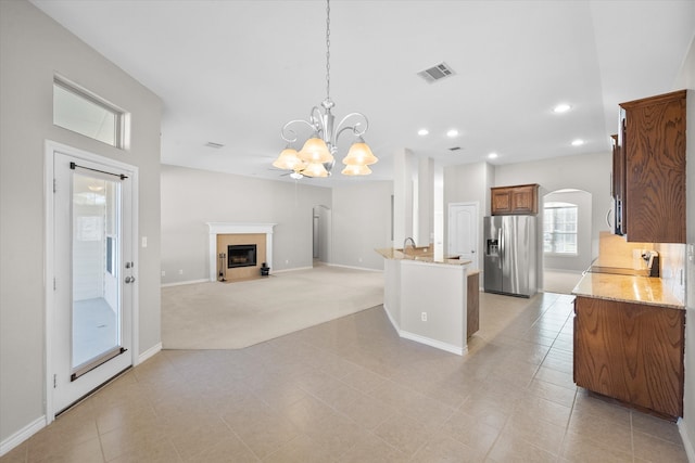 kitchen featuring hanging light fixtures, light tile patterned floors, stainless steel appliances, and a notable chandelier