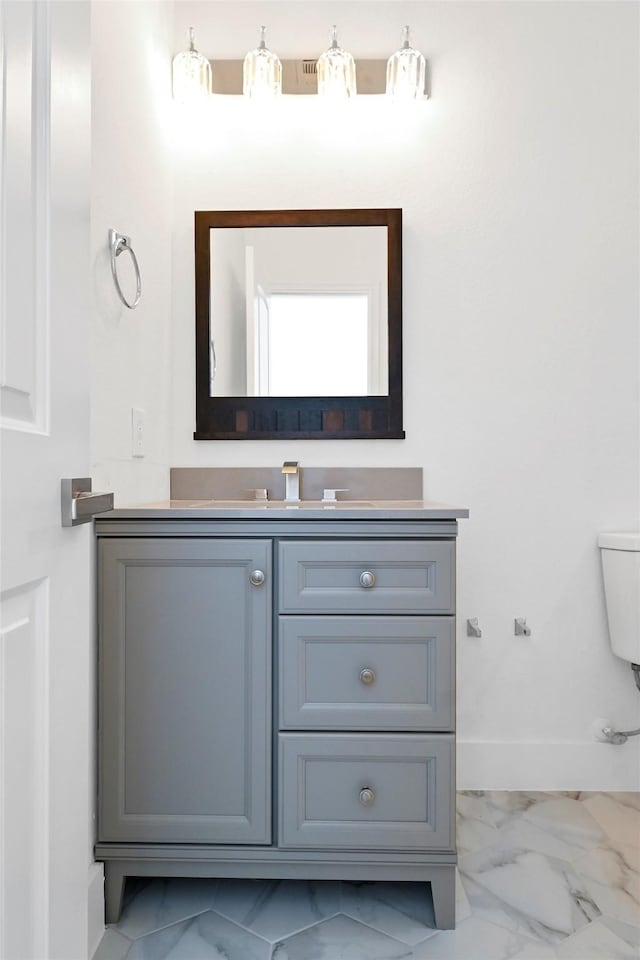 bathroom featuring vanity and toilet