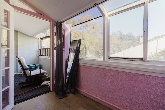 sunroom / solarium featuring vaulted ceiling and a healthy amount of sunlight