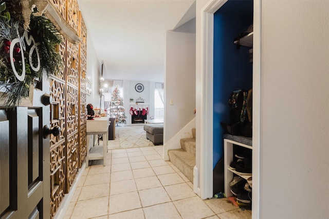 entryway featuring light tile patterned floors and a fireplace